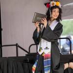 A TAF@Saghalie graduate poses on stage with her diploma. Photo courtesy of Federal Way Public Schools