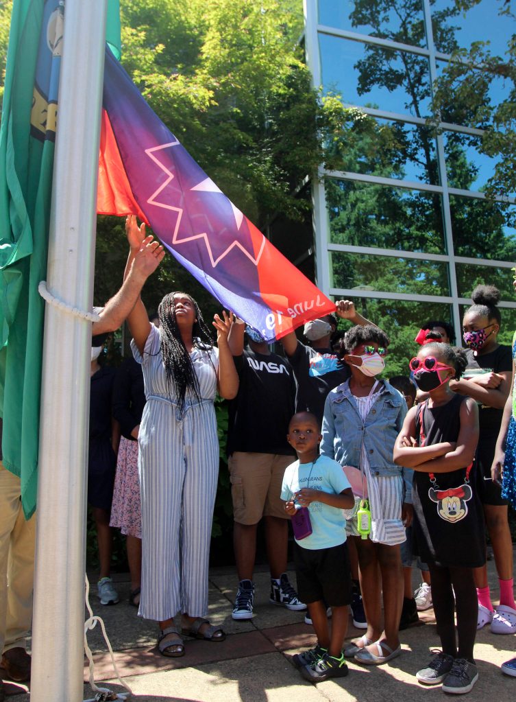 Kids at the June 18 ceremony gathered to assist with the Juneteenth flag raising. Olivia Sullivan/the Mirror