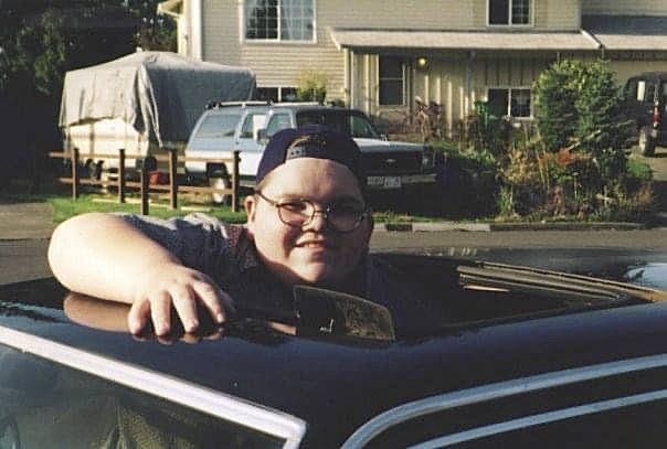 Photos courtesy of Jean Ford
AJ Ford posing for a photo while standing up through the sunroof of his brothers mustang.