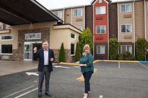 King County Executive Dow Constantine and Auburn Mayor Nancy Backus stand in front of the Clarion Hotel in Auburn on Tuesday July 20. The hotel will be used to house approximately 100 people experiencing homelessness in the area as part of the countys Health Through Housing program. Photo by Henry Stewart-Wood.
