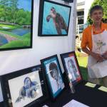 Teen artist Austin Picinich had a busy afternoon Aug. 4 at the FUSION arts festival. His website is austinsart.net. Photo by Andy Hobbs/Federal Way Mirror