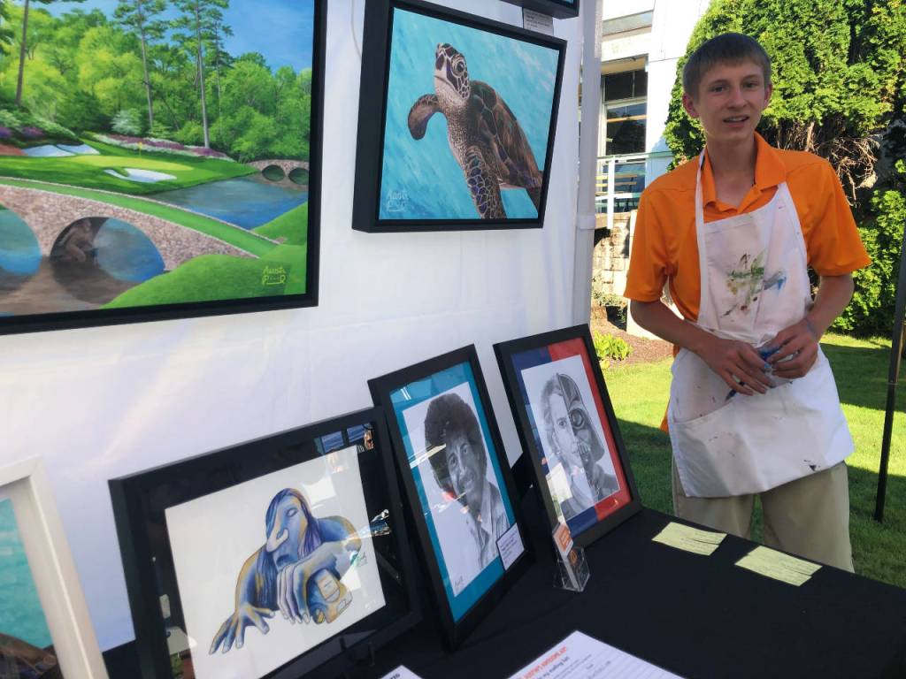 Teen artist Austin Picinich had a busy afternoon Aug. 4 at the FUSION arts festival. His website is austinsart.net. Photo by Andy Hobbs/Federal Way Mirror