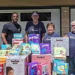 Kent-AM members Isiah Tate, Jim Schwarting, Char Grinolds and Shannon Madison with some of the 9,156 diapers their club collected and 1,132 baby wipes that the Kentridge High School Key Club collected.