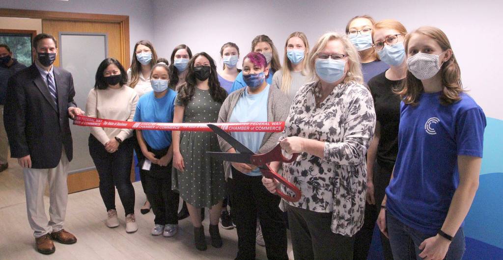 Employees of the Caravel Autism Health clinic pose for a photo with Mayor Jim Ferrell and Chamber CEO Rebecca Martin. Olivia Sullivan/the Mirror
