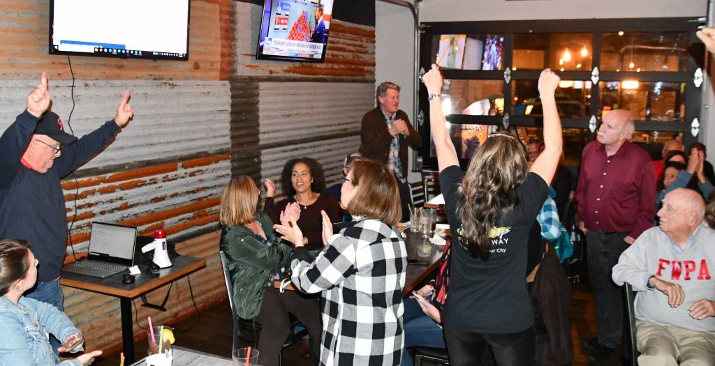 Community members cheer at an election night party at Billy McHales on Nov. 2. Photo courtesy of Bruce Honda