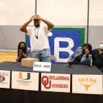 Malik Agbo places a Texas Longhorns cap on after revealing his decision on Dec. 15. Photo courtesy of Federal Way Public Schools
