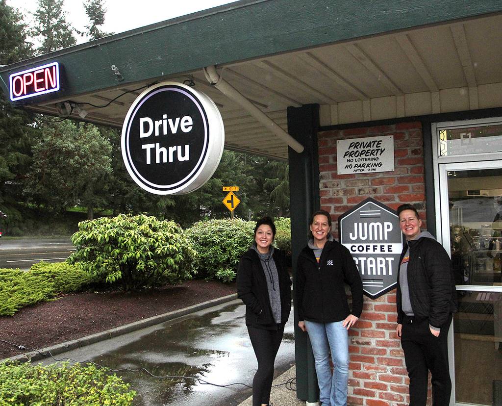 From left, manager Stefanie Reynaud, owner Mykel Papke and owner Stephanie Papke smile in front of the Jump Start Espresso coffee shop in Twin Lakes. Olivia Sullivan/the Mirror