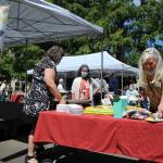 Olivia Sullivan/the Mirror
Village Green Executive Director Kim Salas cuts the birthday cake on July 22, 2021 while celebrating the 100th birthdays of three residents.