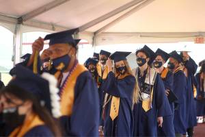 Decatur graduates at an outdoor ceremony move their tassels from right to left on June 12, 2021. Olivia Sullivan/the Mirror