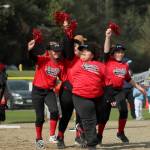 Fastpitch players carry sparkly pompoms as they run the bases on April 23. Olivia Sullivan/the Mirror