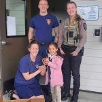 Driver Engineer Hoag, bottom left, Firefighter Pinkstaff, and Federal Way Animal Control Officer Larson stand with a girl after ducklings are dropped off at Station 63. Photo courtesy of the Federal Way Police Department