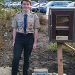Boy Scout Dustin Cole next to the Little Free Library near Panther Lake Trail. Courtesy photo