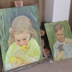 Along with sculpture, Irene Graham is a talented painter, whose late son Michael inspired the painting on the right, showing a young Michael feeding a small rabbit. Photo by Bailey Jo Josie/Sound Publishing