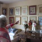 Wearing a shawl she crocheted herself, Irene Graham shows her impressionist art and some of her porcelain dolls that she made herself. Photo by Bailey Jo Josie/Sound Publishing