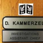 A screenshot from an investigators report about the Nazi symbol Kent Police Assistant Chief Derek Kammerzell placed above his nameplate on his office door.