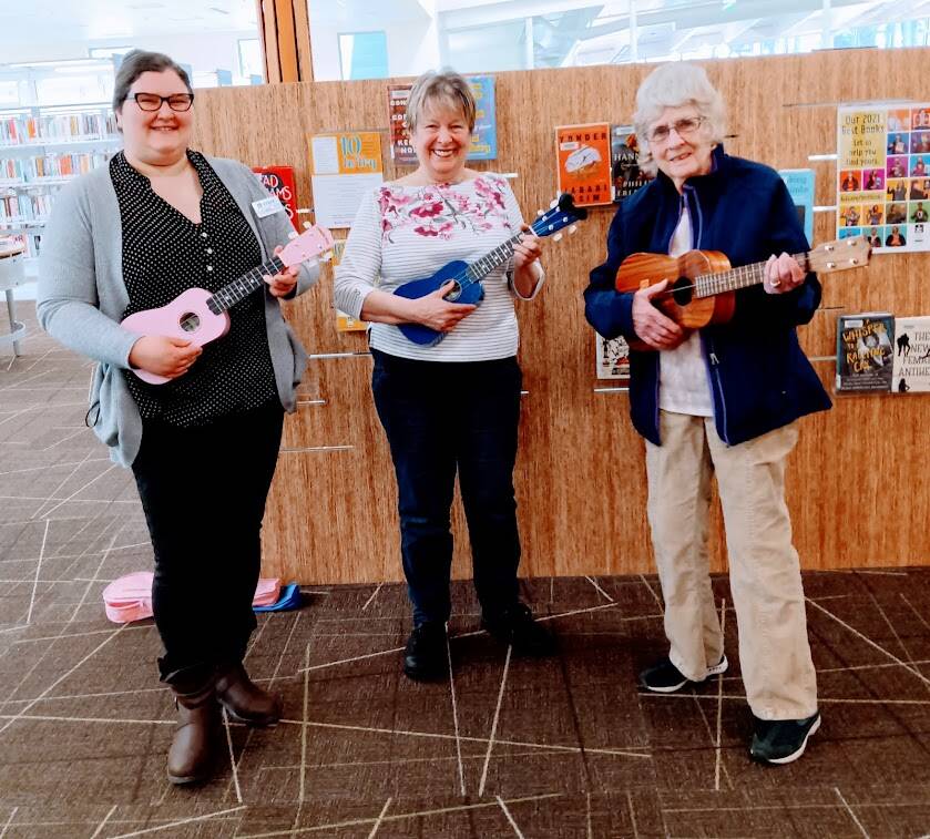Megan Willan, Jan Barber, and Elna Aki playing ukuleles