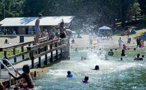 Jonah Tauiliili-Tunupopo, 16, jumps into Steel Lake on June 28, 2021. Olivia Sullivan/the Mirror