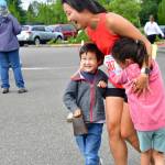A participant hugs two young supporters on July 4. Photo by Bruce Honda