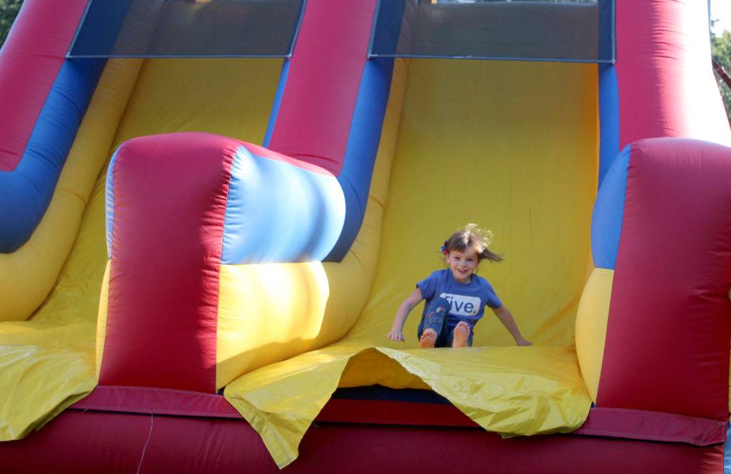 Violet slides down the inflatable obstacle course on July 4. Olivia Sullivan/the Mirror
