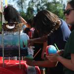 Two people douse their shaved ice from Pac Island Grill in fruity flavors on July 4. Olivia Sullivan/the Mirror