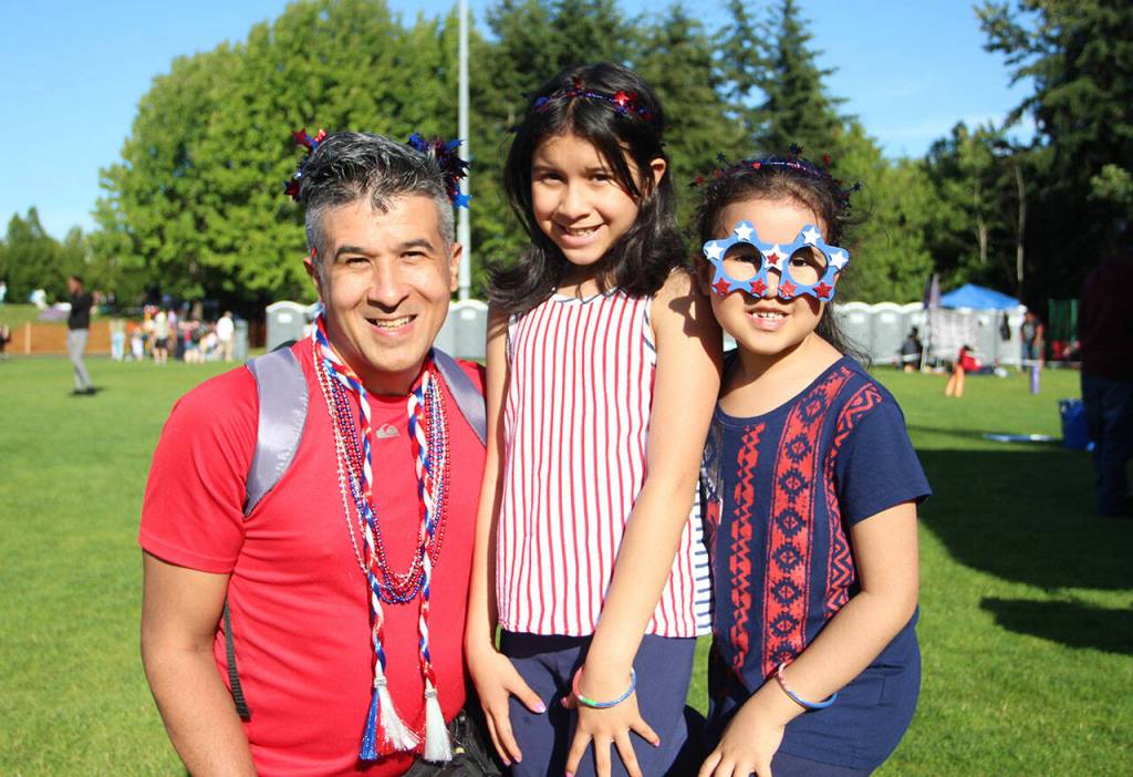 A father and his daughters pose for a photo after a stop at the arts & crafts tent. Olivia Sullivan/the Mirror