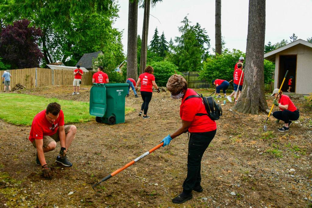 Volunteers provide yard services to FUSION Transitional Housing homes and senior citizens on July 9. Photo courtesy of Shelley Pauls