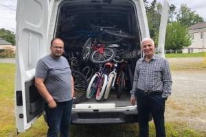 Theres no room to spare in the Lutheran Community Services Northwest van as staff members Mohammad Musa Salangi (left) and Aziz Ahmad Zaheer pick up donations from the Bikes for Kids organization. Courtesy photo