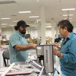 Co-owner Mahfooz Hejran (left) sells a coffee maker and other home items to a customer at Save By The Day. Photo by Bailey Jo Josie/Sound Publishing.