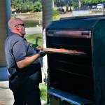 John Hatcher of Cafe Pacific makes the star of the show, the maple rub salmon, on July 22.