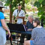 People play some tunes at the Light of Christ Community Garden on Aug. 2. Photo by Bruce Honda