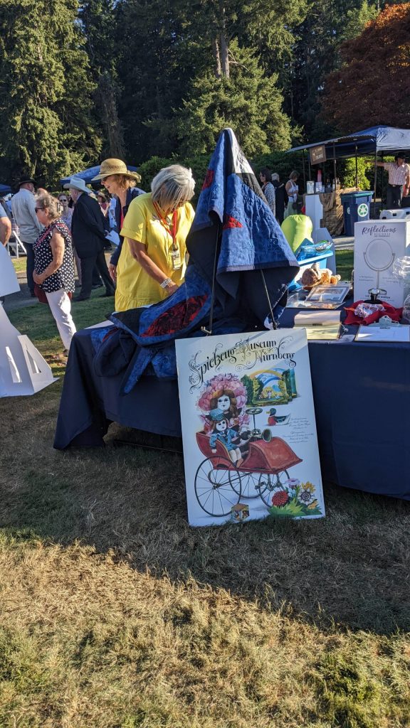 Silent auction bid items at FUSION Art Event August 3. Photo by Sarah Fox.