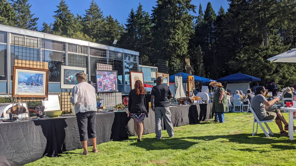 Guests examining silent auction items at FUSION Art Event August 3. Photo by Sarah Fox.