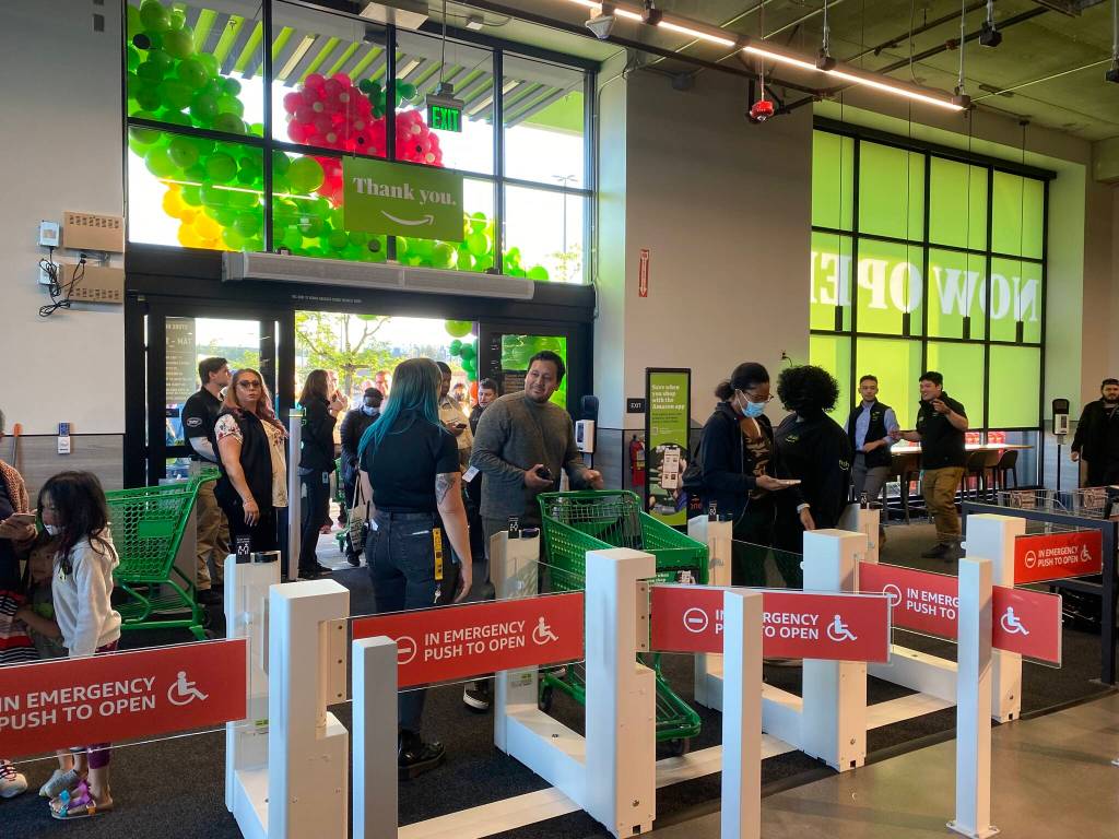 People scan to enter the Amazon Fresh store on Aug. 11. Scanning their app allows the customer to later skip the traditional checkout and charges their card using Just Walk Out technology. Olivia Sullivan/the Mirror