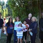 Marwa Almasri, center in blue, accepted a $1,000 donation on behalf of Jay Barbour on Aug. 16. The donation funds were collected by community donations and a portion of sales from K.C. Deez BBQ. From left: Mayor Jim Ferrell; Eileen Wilson of Pacific Christian Academy; Marwa Almasri and her daughter, Nai Barbour and her son, Majed Barbour; Rose Ehl of the Federal Way Farmers Market and her husband, Dave; and K.C. Deez BBQ owner De Davis. Olivia Sullivan/the Mirror