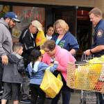 Photo courtesy of Shelley Pauls
In this 2018 file photo, community volunteers gather with South King Fire and Rescue volunteers to collect donations for the annual Mayors Day of Concern for the Hungry.