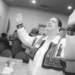 In this Mirror file photo from 1998, Antoinette Smith raises her arms to God while attending Women Who Pray at the Ole Country Buffet.