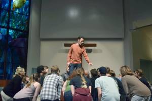 Carl Church, playing Professor Harold Hill, sweet talks the residents of River City during a practice session at St. Lukes Church. Alex Bruell/Sound Publishing