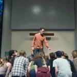 Carl Church, playing Professor Harold Hill, sweet talks the residents of River City during a practice session at St. Lukes Church. Alex Bruell/Sound Publishing