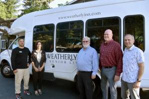 From left to right: Weatherly Inn Assisted Living Project Manager Joshua Magana and General Manager Andrea Peterson, and Christs Church leaders Mac Hoover, Jeff Moorehead and Jim Low each pose for a picture with the shuttle van Weatherly Inn has donated to the church. Photos by Alex Bruell.