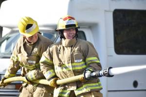 Around three dozen women practiced hauling equipment, handling hoses and rescuing victims at a training event last weekend in Federal Way at South King Fire and Rescues Station 68. Photos by Alex Bruell