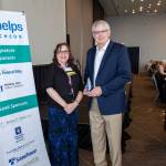 Multi-Service Center CEO Robin Corak presents Marty Kooistra with the 2022 Help, Hope, Change award.