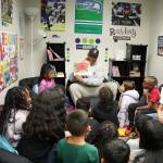 Uchenna Nwosu reads Clifford Makes the Team to kids at the Federal Way Boys and Girls Club on Dec. 5. Photo courtesy of the Seattle Seahawks