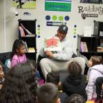 Uchenna Nwosu reads "Clifford Makes the Team" to kids at the Federal Way Boys and Girls Club on Dec. 5. Photo courtesy of the Seattle Seahawks