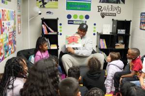 Uchenna Nwosu reads "Clifford Makes the Team" to kids at the Federal Way Boys and Girls Club on Dec. 5. Photo courtesy of the Seattle Seahawks