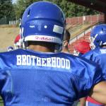 The Federal Way High School football team wears practice jerseys with the word brotherhood on the back to honor former teammate Allen Harris. Photo by Olivia Sullivan, the Mirror