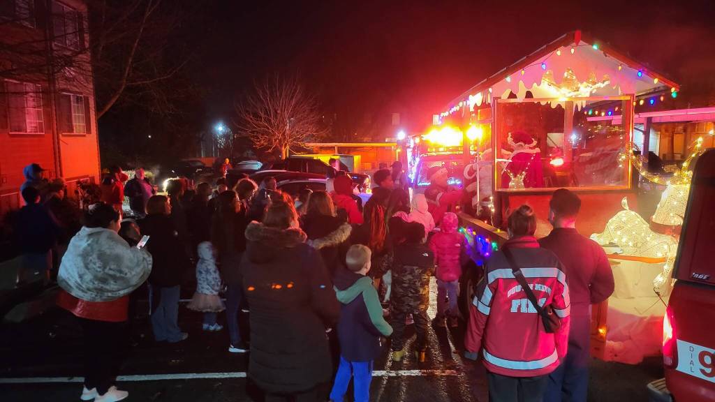 Community members gather to see Santa and Mrs. Claus during a December Santa Parade. Photo courtesy of South King Fire and Rescue