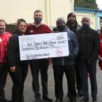 From left, Chick-fil-A Operating Partner DJ Phelps; Angel Tobin, outreach director of Feeding Our Community food distribution; Chick-fil-A Federal Way Owner Ryan Powell; Executive Director Louis Guiden Jr.; John Nalls, mentor coordinator for Brothers Bout Business mentoring program; Good Shepherd Youth Outreach Board Chair Curtis Retic; and Chick-fil-A Marketing Director Allison Lichty. Olivia Sullivan/the Mirror