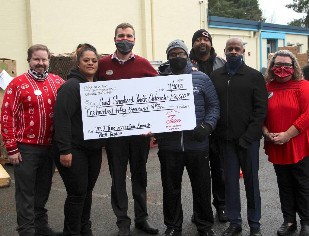 From left, Chick-fil-A Operating Partner DJ Phelps; Angel Tobin, outreach director of Feeding Our Community food distribution; Chick-fil-A Federal Way Owner Ryan Powell; Executive Director Louis Guiden Jr.; John Nalls, mentor coordinator for Brothers Bout Business mentoring program; Good Shepherd Youth Outreach Board Chair Curtis Retic; and Chick-fil-A Marketing Director Allison Lichty. Olivia Sullivan/the Mirror