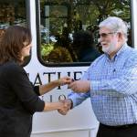 Andrea Peterson officially hands the keys to a new van to Mac Hoover of Christs Church in Federal Way. Alex Bruell/Sound Publishing