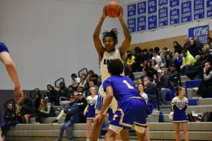 Senior Vaughn Weems raises the ball above his head, as he looks for his teammates. Ben Ray/The Mirror